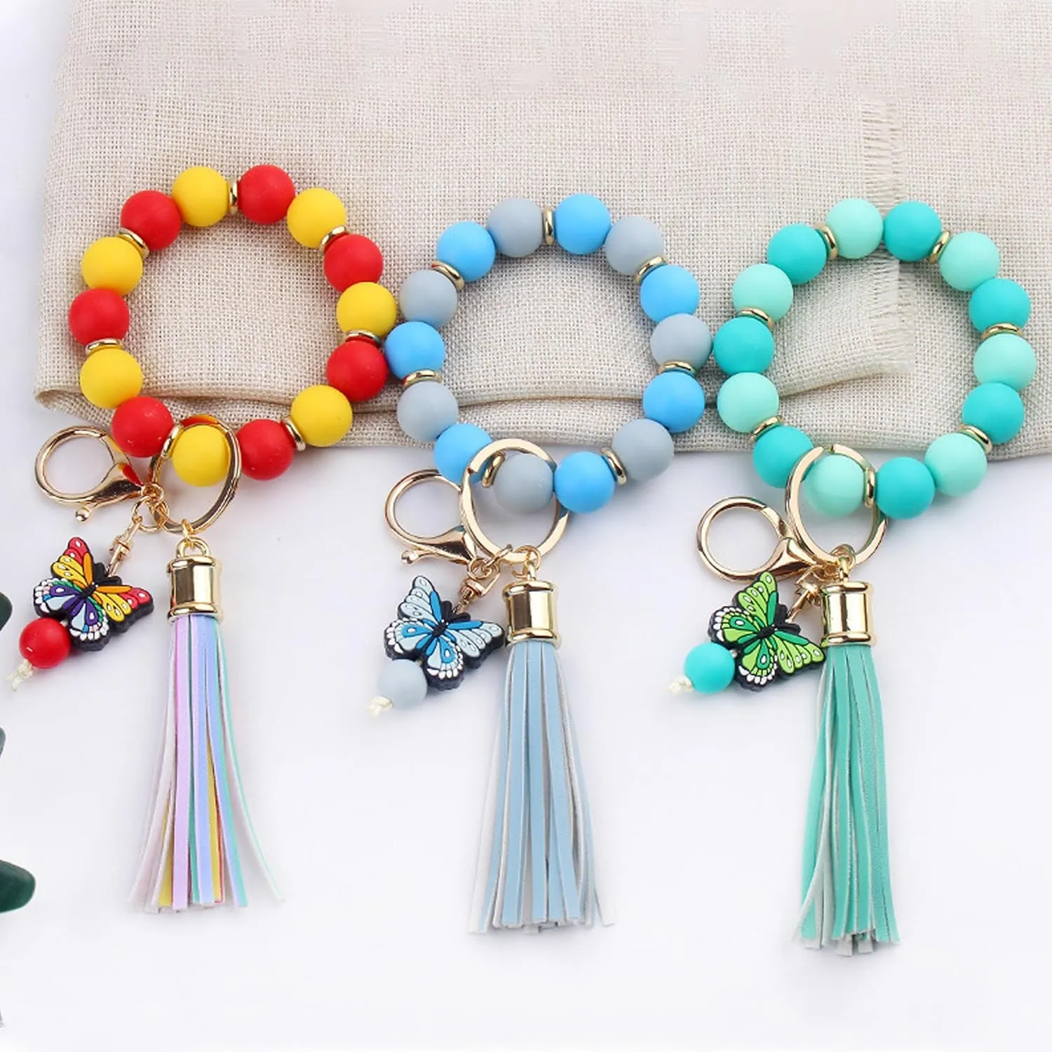 Butterfly Keychain Bracelet for Women,Leather PU Tassel Wrist Bangle Pendant Keyring,Silicone Beaded Wristlet Key Chains